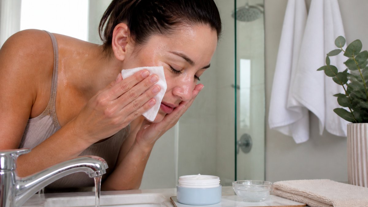 A professional gently cleansing skin with cool water during a chemical peel aftercare routine